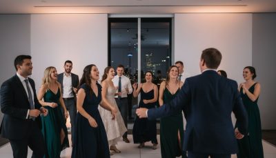Wedding guests dancing and celebrating on the dance floor.